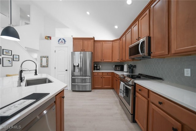 2532 Blackburn Cir, Cape Coral, FL 33991 - kitchen featuring stainless steel appliances, a sink, brown cabinetry, light countertops, and high vaulted ceiling