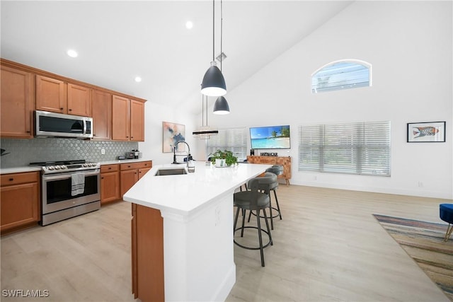 2532 Blackburn Cir, Cape Coral, FL 33991 - kitchen featuring appliances with stainless steel finishes, a sink, high vaulted ceiling, brown cabinetry, and light countertops