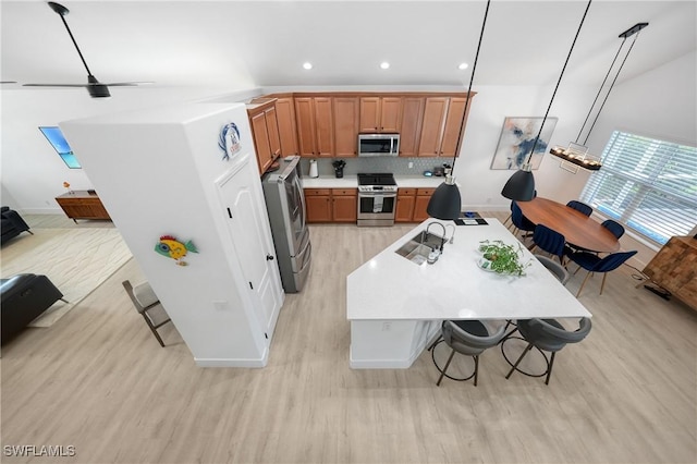2532 Blackburn Cir, Cape Coral, FL 33991 - kitchen with appliances with stainless steel finishes, light wood-style flooring, light countertops, recessed lighting, and decorative backsplash