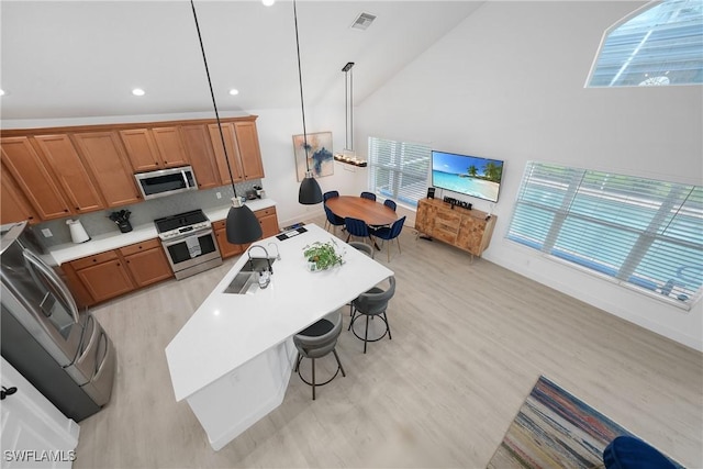 2532 Blackburn Cir, Cape Coral, FL 33991 - kitchen featuring stainless steel appliances, a sink, plenty of natural light, brown cabinets, and recessed lighting