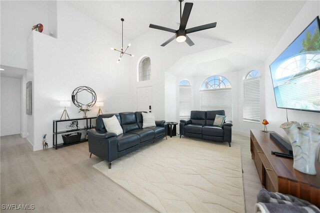 2532 Blackburn Cir, Cape Coral, FL 33991 - living area featuring light wood-style flooring, ceiling fan, high vaulted ceiling, a chandelier, and baseboards