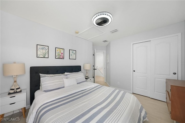 2532 Blackburn Cir, Cape Coral, FL 33991 - bedroom featuring attic access, a closet, light wood-style floors, and baseboards