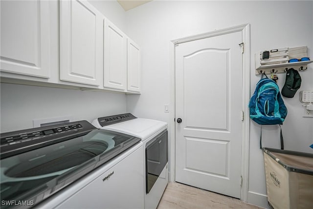 2532 Blackburn Cir, Cape Coral, FL 33991 - clothes washing area featuring washing machine and clothes dryer, cabinet space, and light wood-style floors
