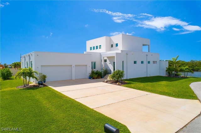 view of front of home with a front lawn and a garage