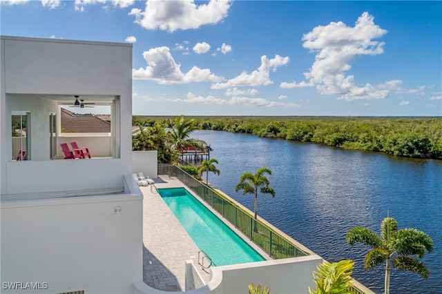 view of pool with a water view and ceiling fan