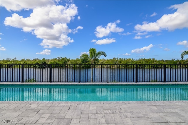 view of pool featuring a water view