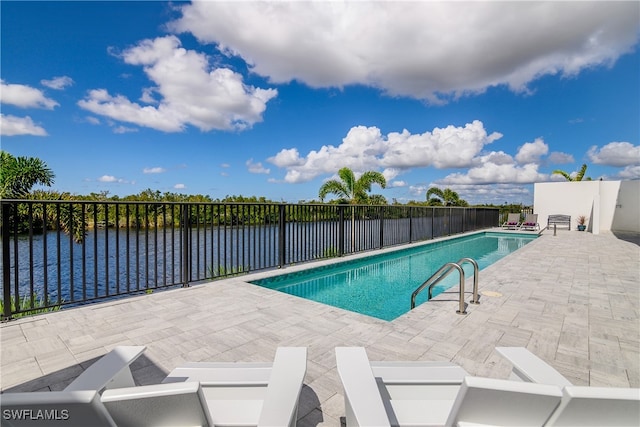 view of swimming pool with a water view and a patio