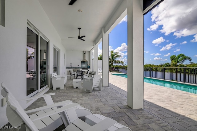 view of patio / terrace featuring a fenced in pool and ceiling fan