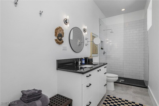 bathroom featuring tiled shower, vanity, and toilet