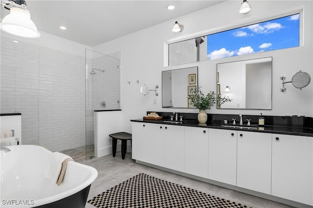 bathroom with vanity and shower with separate bathtub