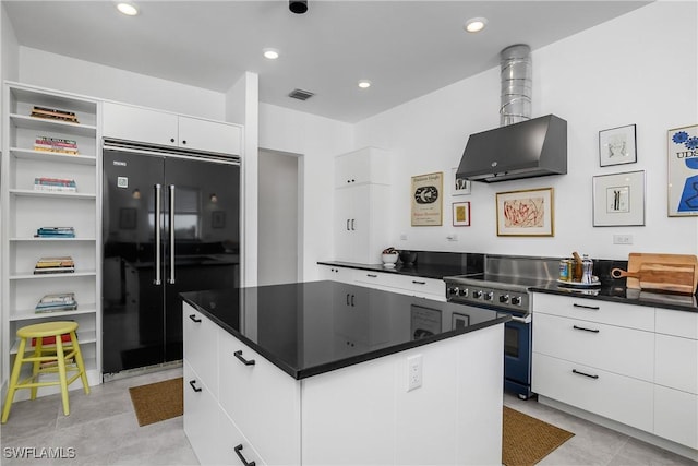 kitchen featuring white cabinetry, a center island, ventilation hood, stainless steel range with electric stovetop, and black refrigerator