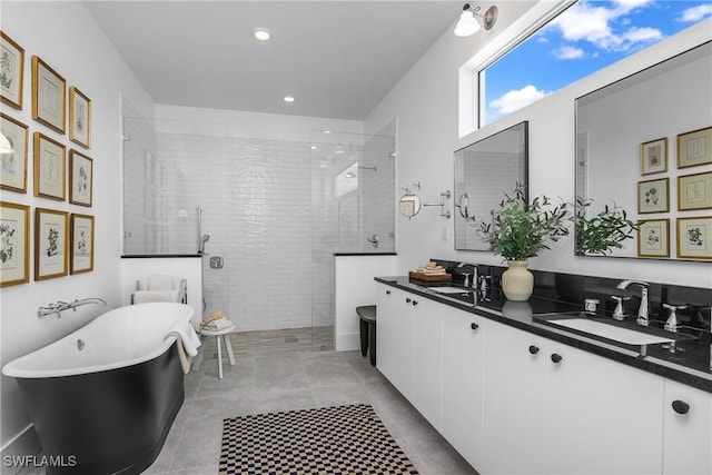 bathroom with tile patterned flooring, vanity, and independent shower and bath