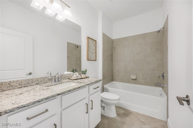 full bathroom with tile patterned floors, vanity, tiled shower / bath combo, and toilet