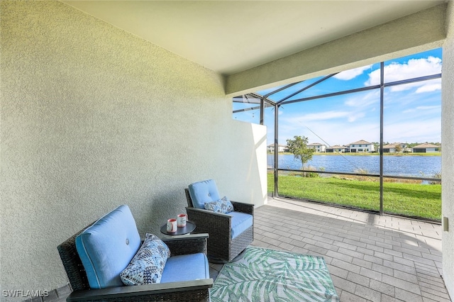 sunroom / solarium featuring a water view