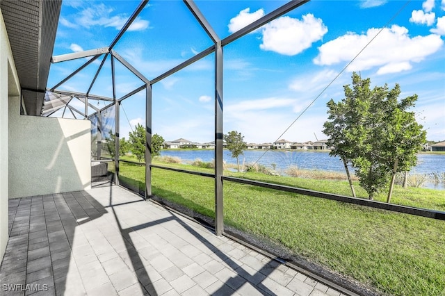 unfurnished sunroom with a water view