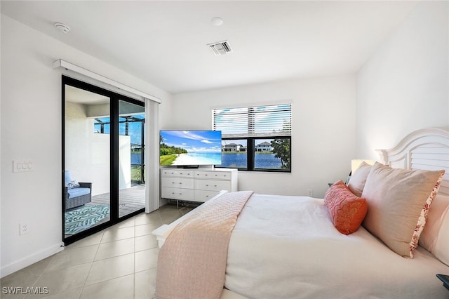 bedroom featuring light tile patterned floors and access to outside