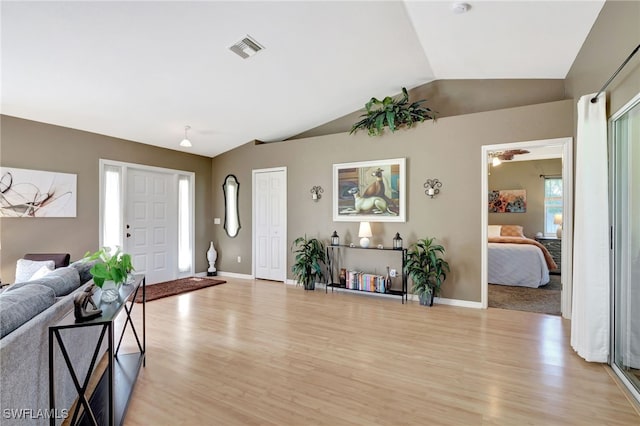 interior space with lofted ceiling and light hardwood / wood-style floors