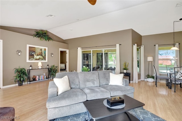 living room with light hardwood / wood-style floors and lofted ceiling