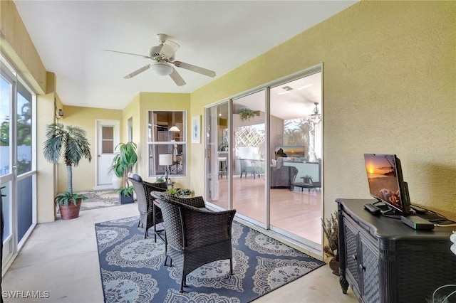 sunroom featuring ceiling fan