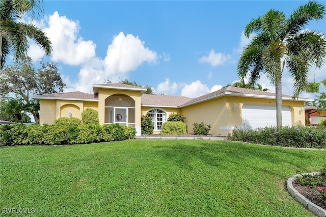 view of front facade with a garage and a front yard