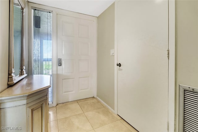 foyer entrance with light tile patterned floors, baseboards, and visible vents