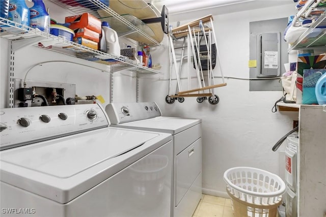 laundry area featuring electric panel, laundry area, light tile patterned floors, and independent washer and dryer