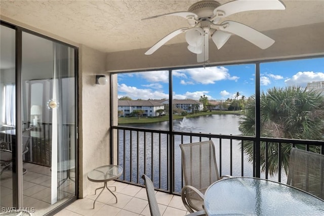 sunroom featuring a water view