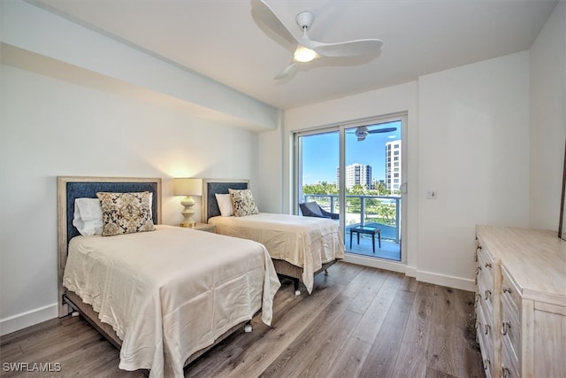 bedroom featuring ceiling fan, wood-type flooring, and access to outside