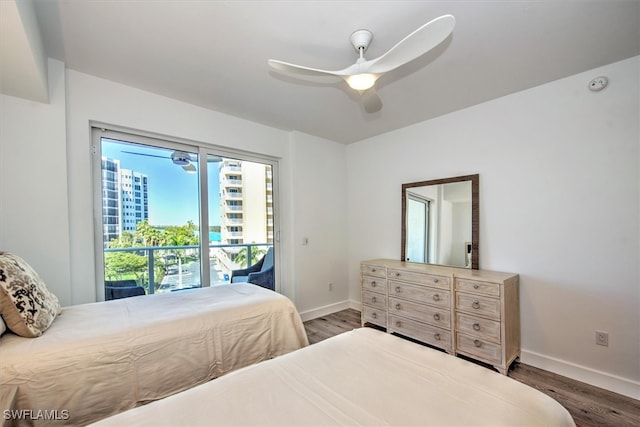 bedroom featuring access to outside, ceiling fan, and dark hardwood / wood-style floors