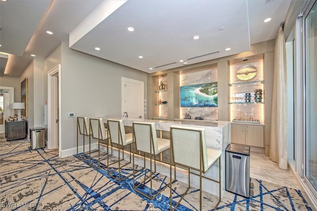 kitchen featuring a kitchen bar and a kitchen island