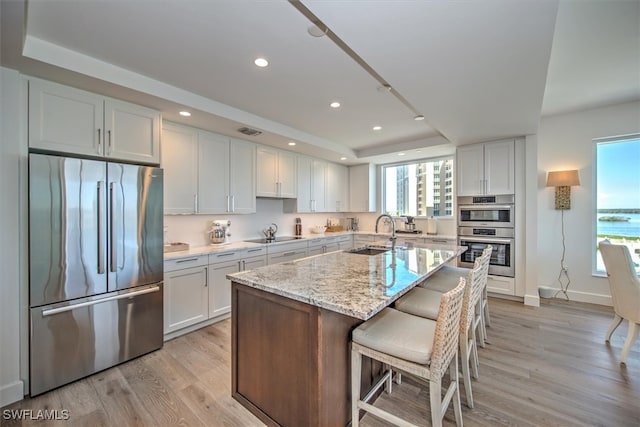 kitchen with white cabinetry, sink, and stainless steel appliances