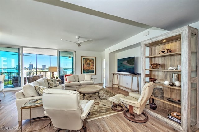 living room featuring hardwood / wood-style floors and ceiling fan