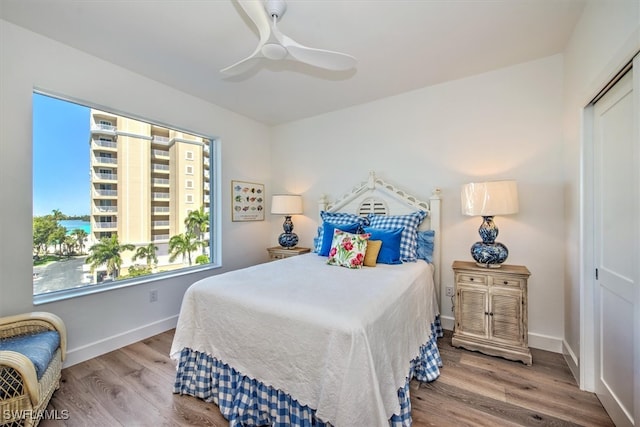 bedroom featuring hardwood / wood-style floors, ceiling fan, and a closet