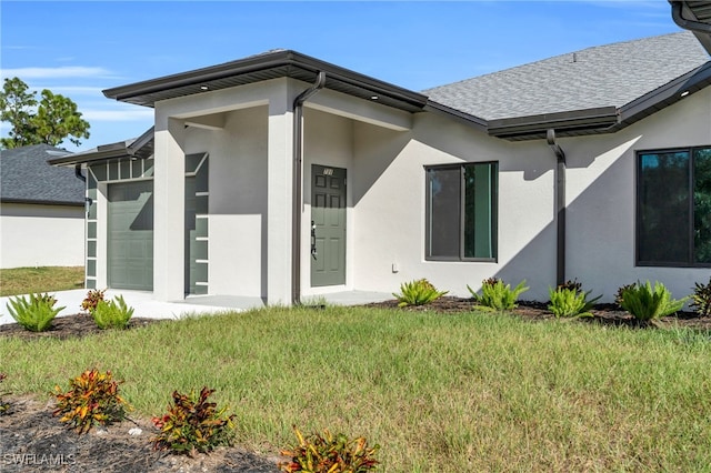 rear view of property featuring a lawn