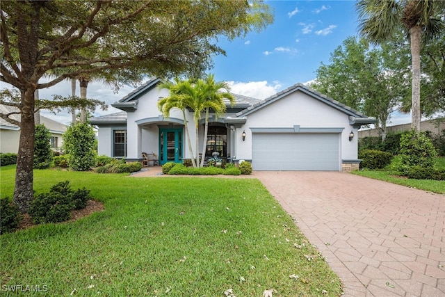 view of front of property with a front yard and a garage