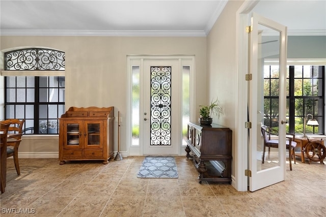 entrance foyer with french doors, a wealth of natural light, and ornamental molding