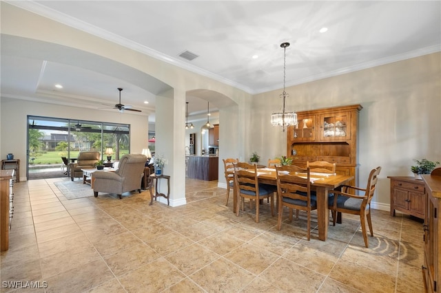 dining area featuring ceiling fan with notable chandelier and ornamental molding