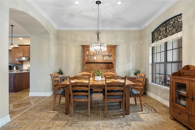 dining area with a chandelier and ornamental molding