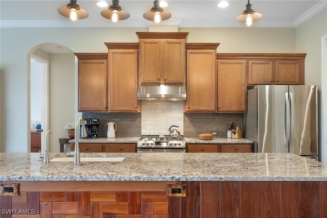 kitchen featuring light stone countertops, tasteful backsplash, stainless steel appliances, crown molding, and sink