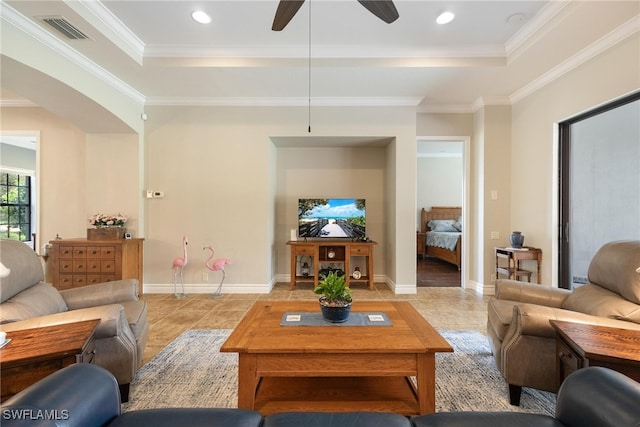 living room featuring a raised ceiling, crown molding, and ceiling fan