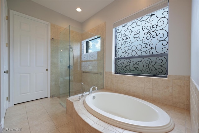 bathroom with tile patterned floors and separate shower and tub