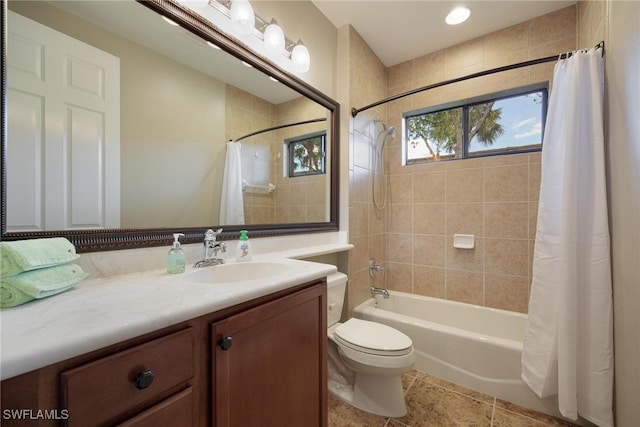 full bathroom with tile patterned floors, shower / bath combo with shower curtain, vanity, and toilet