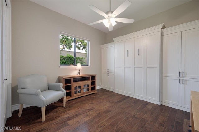 sitting room with dark hardwood / wood-style floors and ceiling fan