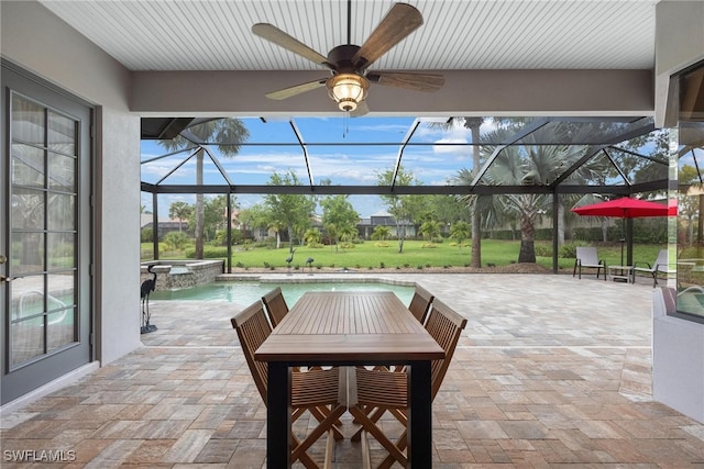 view of patio featuring glass enclosure, ceiling fan, and a swimming pool with hot tub