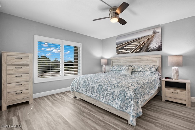 bedroom with hardwood / wood-style floors and ceiling fan