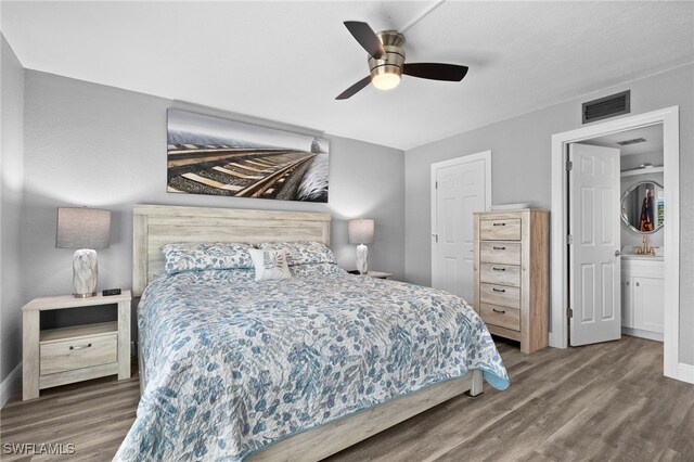 bedroom with hardwood / wood-style flooring, ceiling fan, and ensuite bathroom