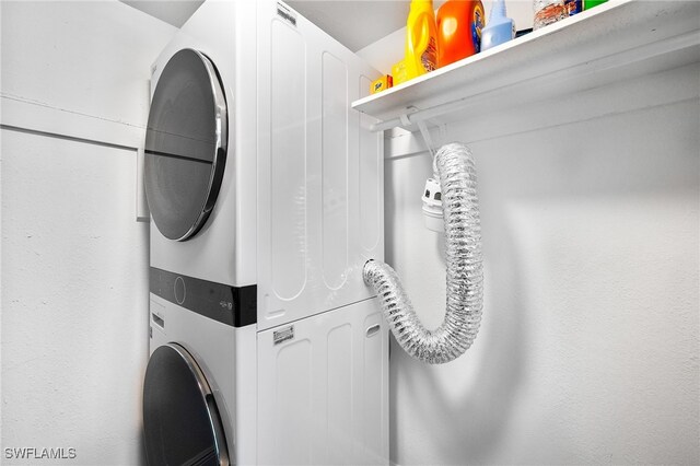 laundry room featuring stacked washer / drying machine