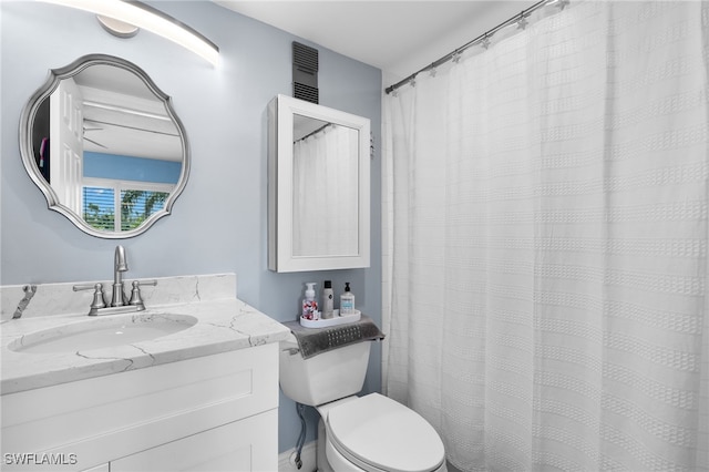 bathroom featuring toilet and vanity