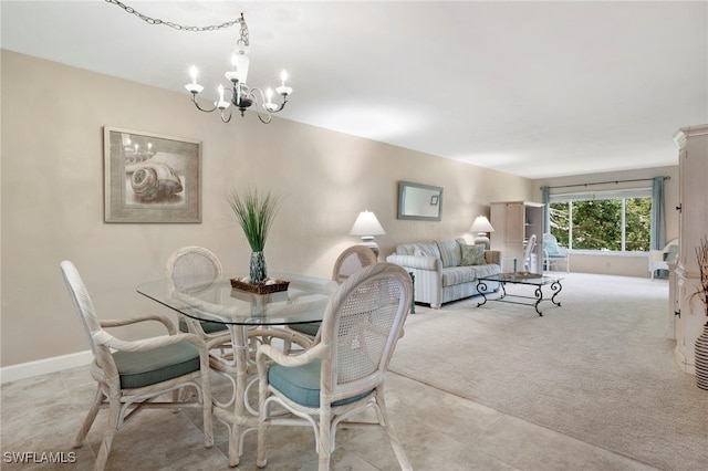 dining room featuring an inviting chandelier and light carpet