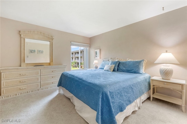 bedroom featuring light colored carpet